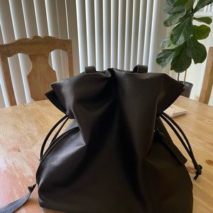 Black leather purse, fully lined with storage bag.